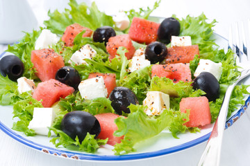 fresh salad with watermelon, feta cheese and olives, close-up