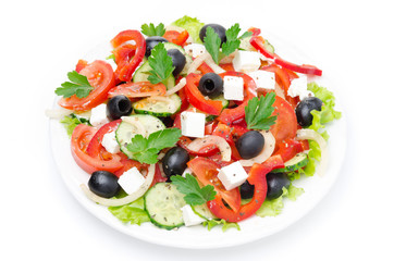 Greek salad with feta cheese, olives and vegetables, top view