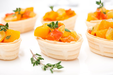 roasted vegetables with thyme in tartlets, close-up