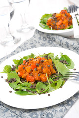 salad with arugula, black lentils, vegetable in tomato sauce