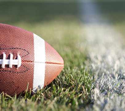 American Football On The Field With Yard Line And Green Grass