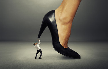 man under big female heel
