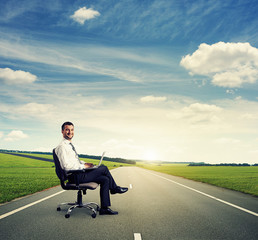 man with laptop on the road