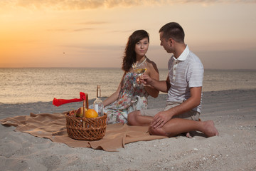 Beautiful Couple On Beach With Wine Picnic