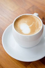 A cup of coffee on wooden background