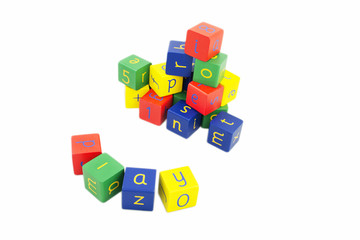 Coloured building blocks with letters on a white background