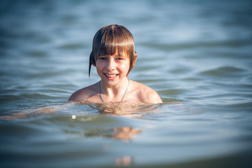 happy little boy in the sea