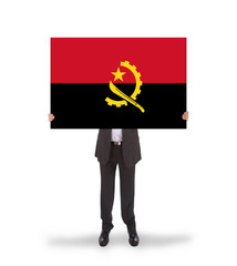 Businessman holding a big card, flag of Angola