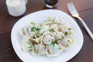 Fresh boiled meat dumplings served with dill