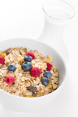 Bowl of muesli with fresh berries an milk