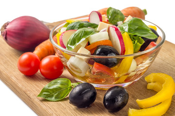 Salad with vegetables around isolated on white background