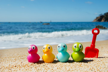 Colorful toy ducks  at beach