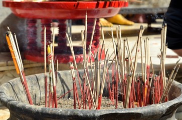 Red joss sticks burn in temple