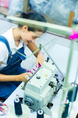 Indonesian seamstress in a textile factory