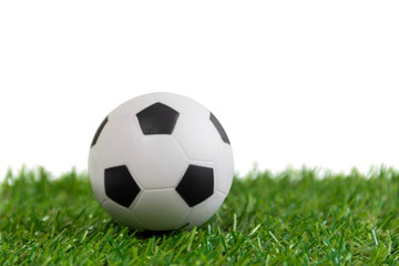 Soccer ball model on artificial green grass over white backgroun