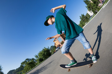 Cheerful boy riding a skateboard on the street.