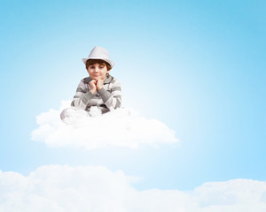 Fototapeta na wymiar Boy sitting on cloud