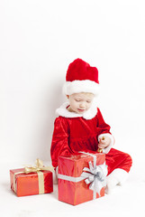 little girl as Santa Claus with Christmas presents