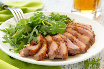 Salad with arugula and duck breast.