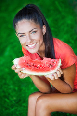 young beautiful brunette woman holding watermelon