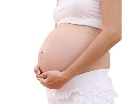 Hand hold abdomen of pregnant woman on white background.
