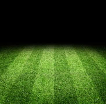 Close up of soccer or football field at night with copy space