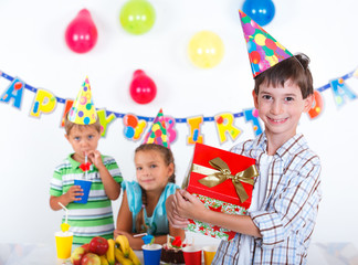 Fototapeta na wymiar Boy with giftbox at birthday party