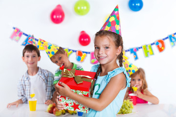 Girl with giftbox at birthday party