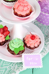 Delicious beautiful  cupcakes on festive table close-up