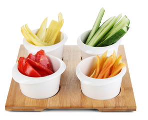 Bright fresh vegetables cut up slices in bowls isolated on