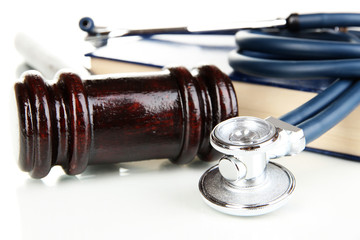 Medicine law concept. Gavel and stethoscope on book close up