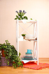 Beautiful white shelves with tableware and decor,