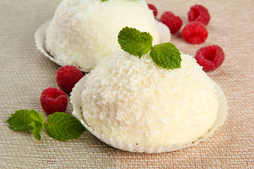Delicious coconut cakes on table close-up