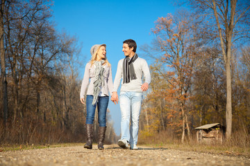 Fototapeta premium Romantic young beautiful couple on autumn walk.