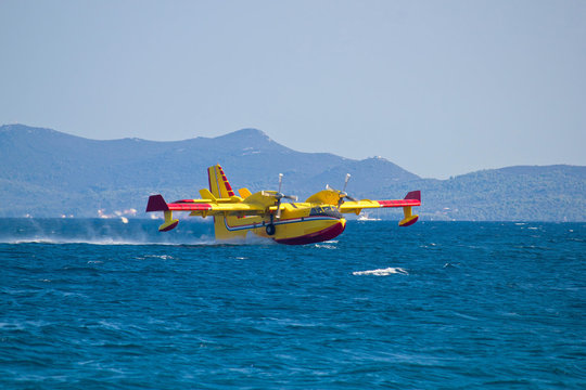 Firefighting airplane taking water from sea