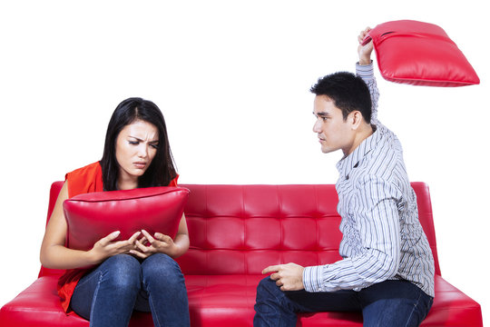 Asian Young Couple Fighting With Pillows