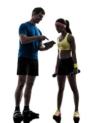 woman exercising fitness  man coach using digital tablet