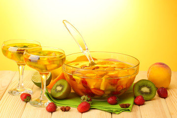 punch in bowl and glasses with fruits,