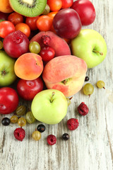 Assortment of juicy fruits, on wooden background