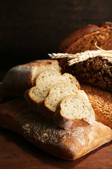 Much bread on wooden board