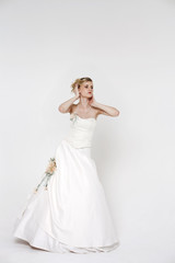 Fototapeta na wymiar Beautiful blonde bride wearing wedding dress