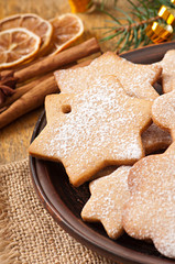 Fototapeta na wymiar Homemade Christmas cookies sprinkled with powdered sugar