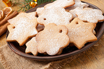 Fototapeta na wymiar Homemade Christmas cookies sprinkled with powdered sugar