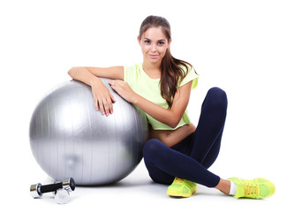 Young beautiful fitness girl with grey ball isolated on white
