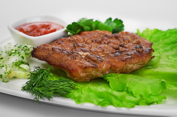 Grilled steak on a white plate