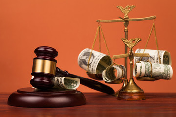 gavel, money , and scales of justice