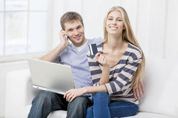 young caucasian couple sitting on couch