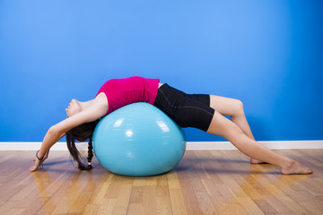 Naklejka premium Fitness woman exercising with ball indoors.