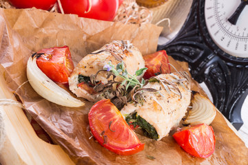 Chicken breast with spinach, baked tomatoes and herbs