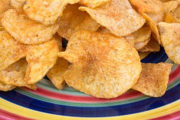 A very close view of red chili flavored chips on plate